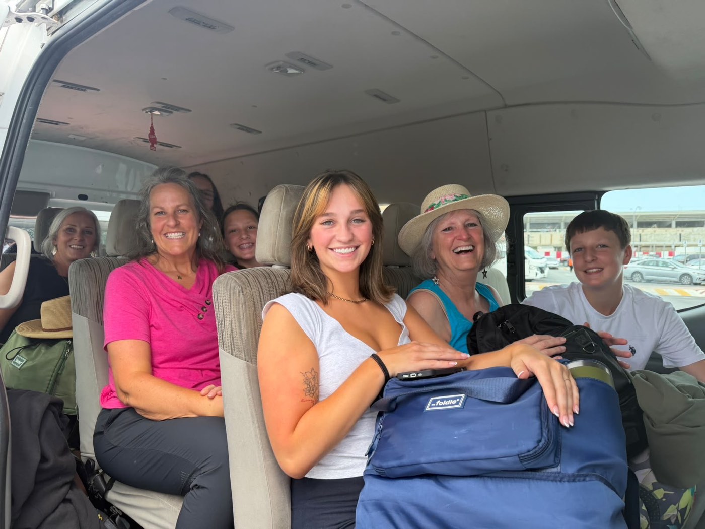 Three generations of one family settled into the van at the pier, bags on their laps, ready to set off
