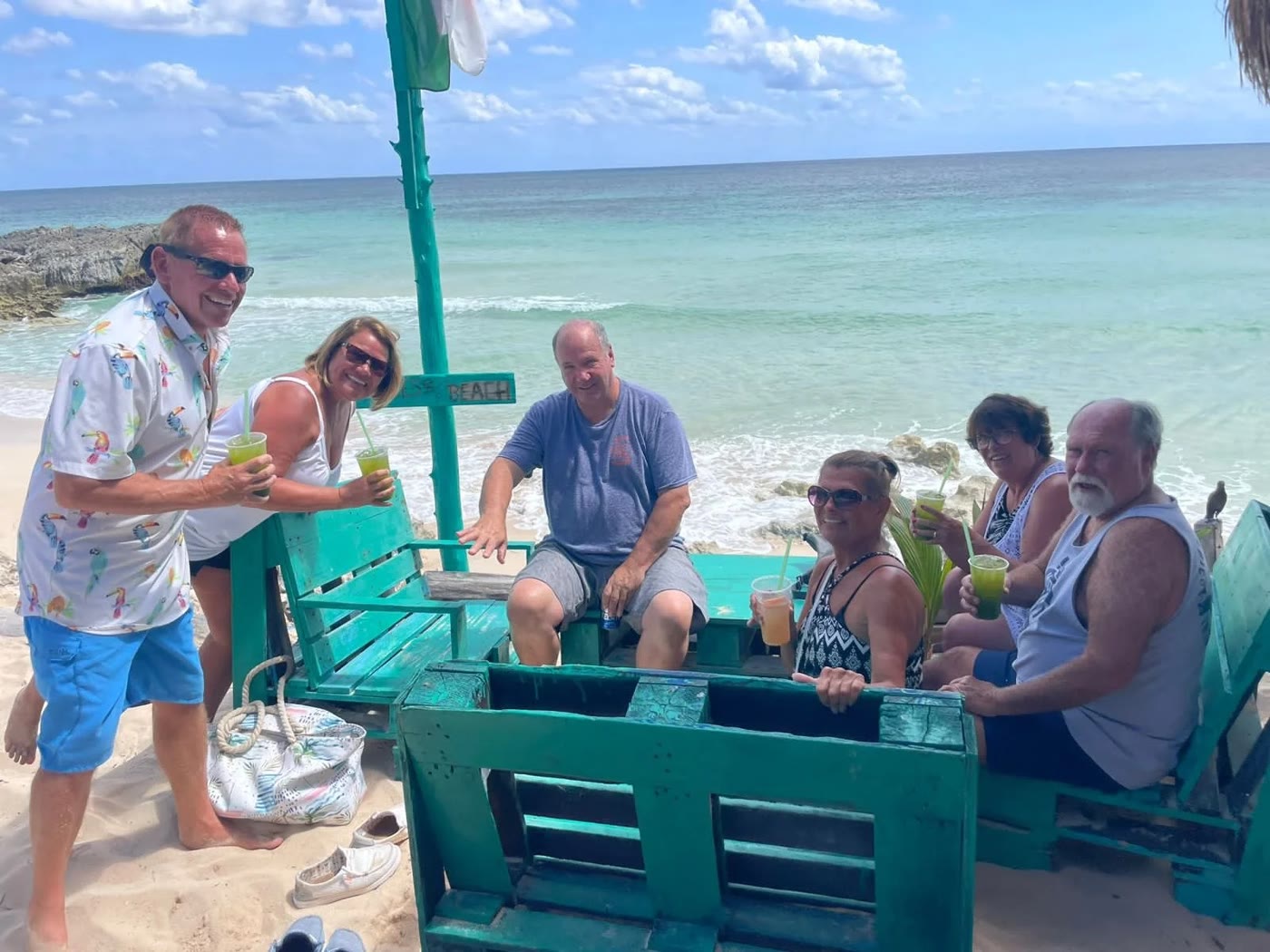 Guests with drinks at a beach bar on the Cozumel coast