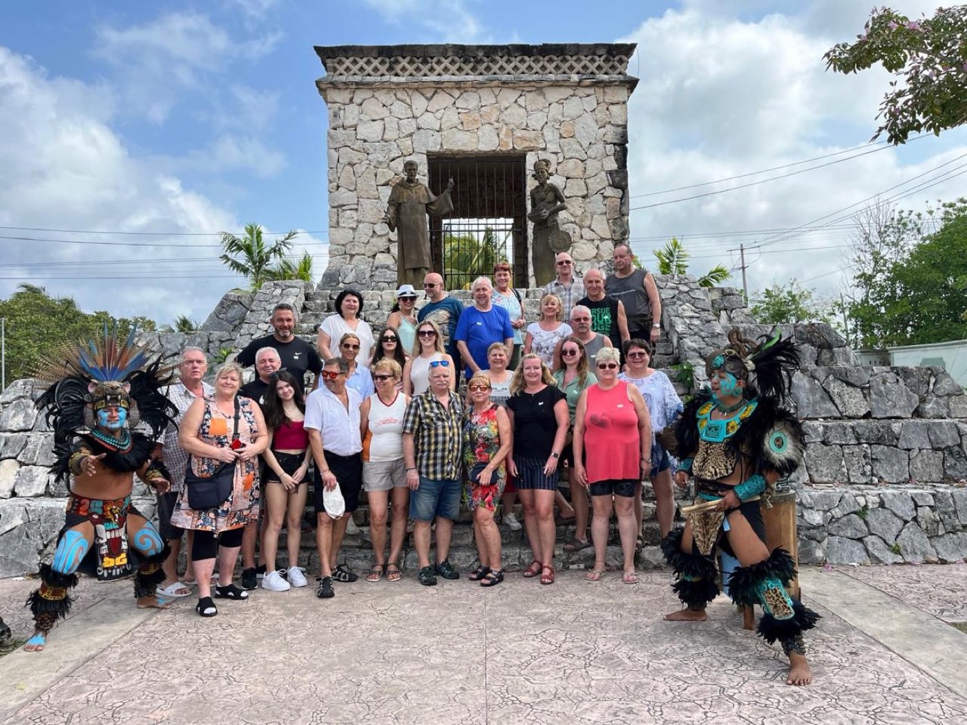 The tour group with Maya dancers at the Mestizaje monument